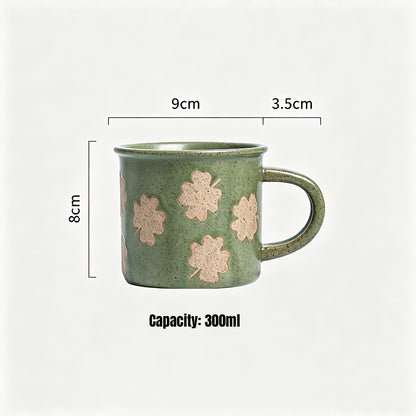 This vintage rough‑ceramic coffee mug comes in two styles, featuring a muted green speckled glaze full of rustic charm. One version is decorated with delicate four‑leaf clover patterns, while the other adopts a two‑tone color‑block design. It is ideal for enjoying coffee, tea, and daily hot drinks.