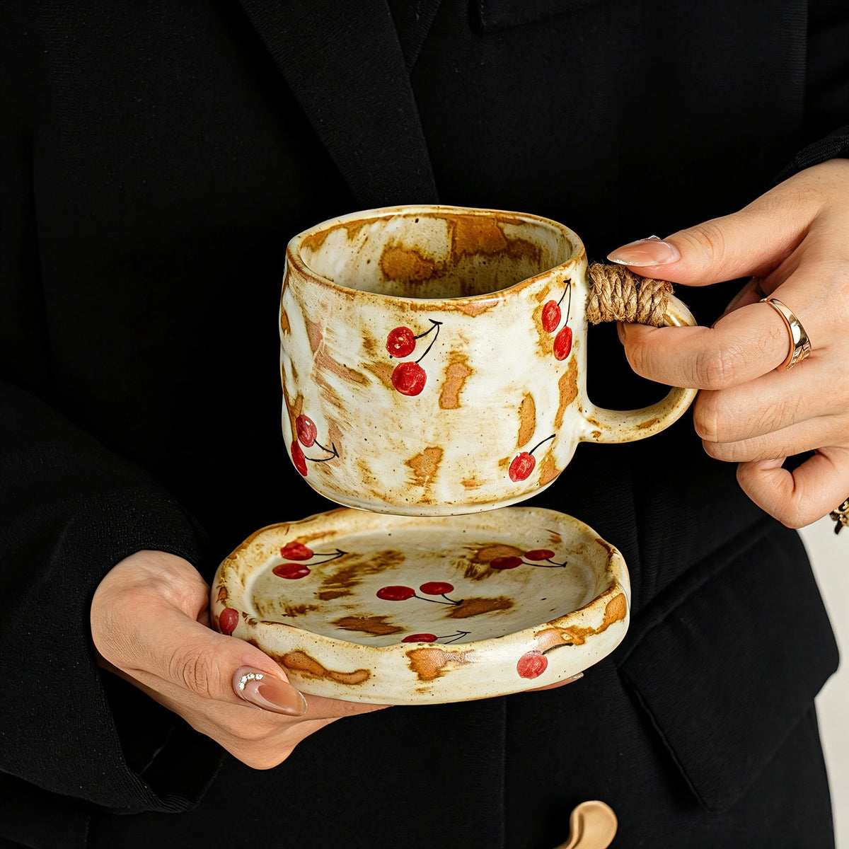 These vintage kiln‑change ceramic mugs feature unique dripping glaze rims and textured hand‑thrown bodies. The handles are wrapped with natural jute rope, adding a rustic artisanal touch. Available in multiple charming colorways, they make lovely daily coffee and tea drinking sets.