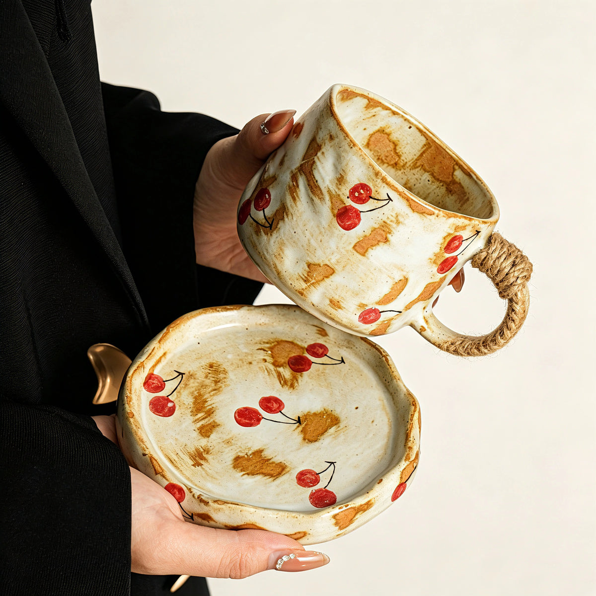 These vintage kiln‑change ceramic mugs feature unique dripping glaze rims and textured hand‑thrown bodies. The handles are wrapped with natural jute rope, adding a rustic artisanal touch. Available in multiple charming colorways, they make lovely daily coffee and tea drinking sets.