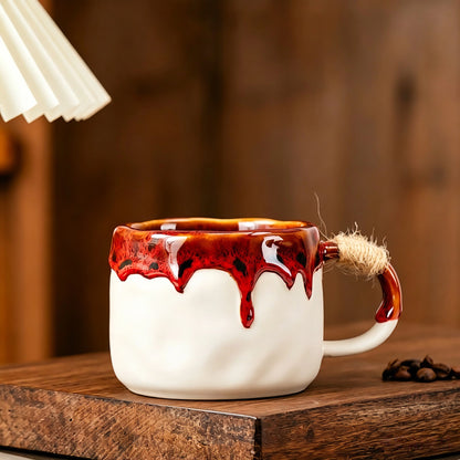 These vintage kiln‑change ceramic mugs feature unique dripping glaze rims and textured hand‑thrown bodies. The handles are wrapped with natural jute rope, adding a rustic artisanal touch. Available in multiple charming colorways, they make lovely daily coffee and tea drinking sets.